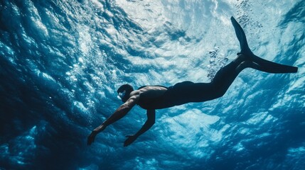 A man is swimming in the ocean with his arms outstretched