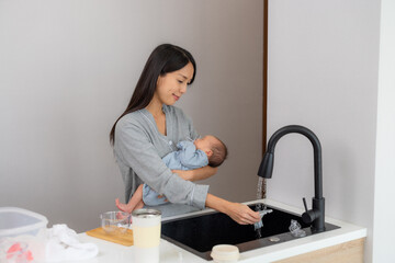 Canvas Print - Asian woman take care her son and wash the baby accessory