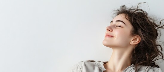 Aufkleber - Profile of a smiling beautiful woman lying on the floor against a white background gazing ahead at empty copy space