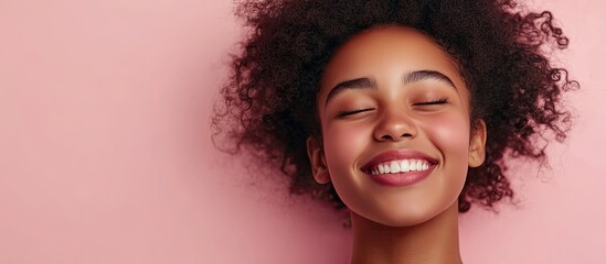 Poster - Joyful charming African American girl isolated against a pastel background Smiling face Genuine emotions. with copy space image. Place for adding text or design