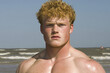 © MacAttack Creations - handsome redhead man on the beach with freckles and sand on his skin