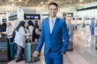 © Minerva Studio - Smiling businessman at airport terminal