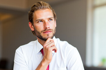 Pensive businessman planning strategy in office environment