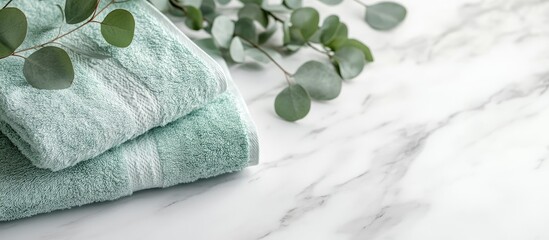 Poster - Fresh towels and eucalyptus branches on a marble table with a white background Space for text. with copy space image. Place for adding text or design