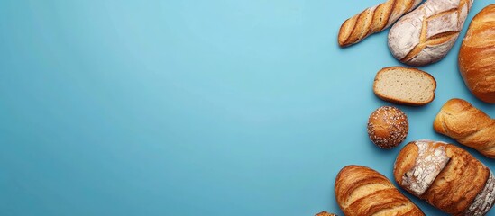 Poster - Top view of bread and bakery items on a blue background Images related to food and health concepts. with copy space image. Place for adding text or design