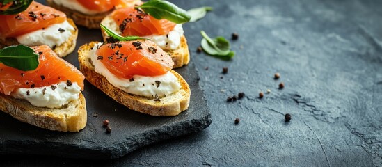 Aufkleber - Baguette slices topped with soft cheese and salmon on a slate board vintage toned. with copy space image. Place for adding text or design