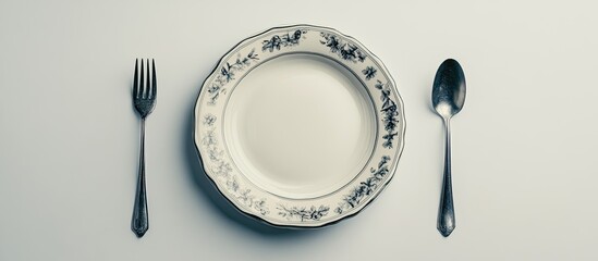 Leinwandbilder - Vintage beautiful plate spoon and fork set against a white background. with copy space image. Place for adding text or design