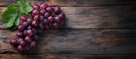 Wall Mural - Bunch of grapes on a rustic wooden surface Top view. with copy space image. Place for adding text or design