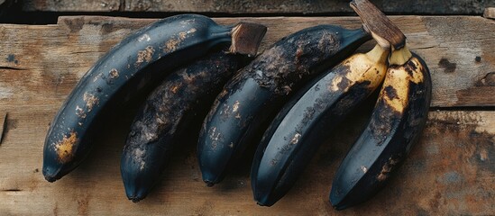 Aufkleber - Ripe bananas start to decay and their skin turns black The bananas are set on a wooden bench Close up photo. with copy space image. Place for adding text or design