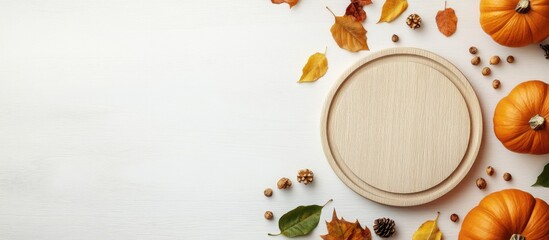 Fototapete - Thanksgiving Day Flat lay arrangement featuring pumpkins leaves and a round board on a light wooden table with space for text. with copy space image. Place for adding text or design