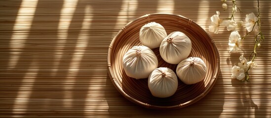 Poster - Massage bundles arranged on a plate on a bamboo mat Spa wellness therapy concept. with copy space image. Place for adding text or design
