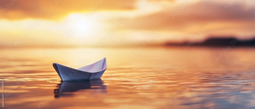 Paper boat afloat on water's surface, sun setting behind ocean backdrop ...