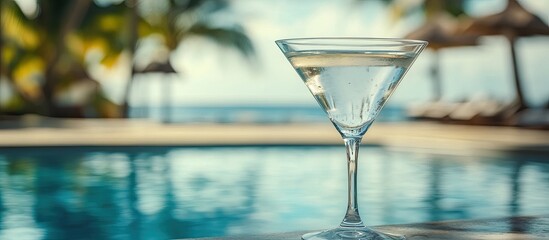 Aufkleber - Dry martini cocktail in a glass by the pool at a tropical resort Vertical. with copy space image. Place for adding text or design