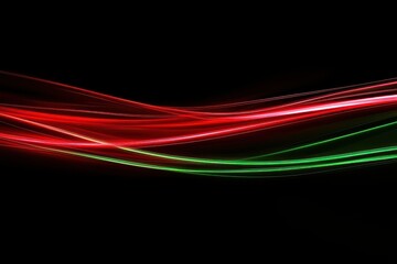 Leinwandbilder - Colorful light trails in red and green create an abstract pattern against a dark background