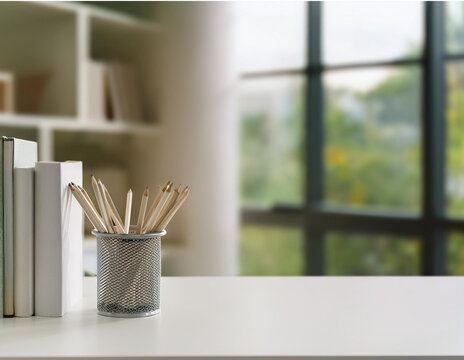 A blurring study room background with a white table containing books and stationery with text space