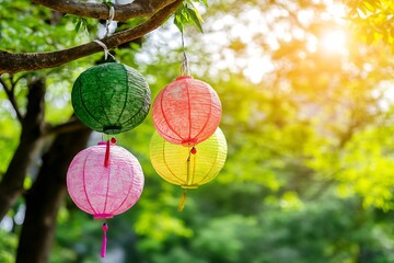 Poster - Colorful paper lanterns in green pink and yellow hanging from tree in bright sunlight : Generative AI