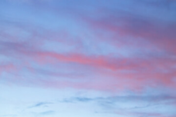 Wall Mural - A beautiful sky tinted by the sun leaving vibrant shades of gold, pink, blue and multicolored. Clouds in the twilight evening and morning sky. Cloudy sky background in the evening, and during the day.