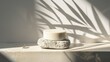 © kitipol - Empty Podium for product display with lef shadow background.