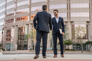 Successful partnership in business deal. Businessmen dealing outdoor. Partnership success. Celebrate business partnership. Two businessmen partner celebrating business deal. Business relationship