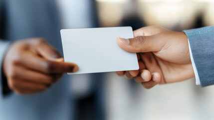 Wall Mural - Business Card Exchange: Close-up shot of two businesspeople exchanging a blank business card.  A moment of connection and networking.