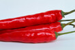 © Yessi Frenda - Fresh red big chili with green stem, isolated on white background