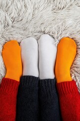 Colorful socks on soft rug, cozy winter vibes for any occasion.