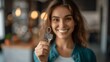 © k - Smiling Realtor Holding Keys and Documents Offering Apartment Deal
