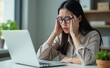 © ARSALAN - Women Hold His Head Headaches in her head , girl wearing glasses using laptop thinking