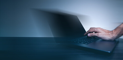 Poster - shirt works in a modern office. the man is typing on a laptop