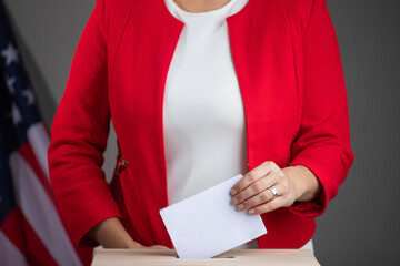 Wall Mural - Voting women near ballot box on table against flag of USA