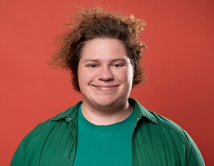 Portrait of Handsome Young Man Happily Smiling Against Colored Studio Background