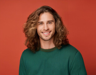 Portrait of Handsome Young Man Happily Smiling Against Colored Studio Background