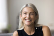 © fizkes - Head shot portrait 60 years old smiling grey haired lady on retirement looking at camera making video call enjoying happy life. Profile picture of beautiful stylish middle aged woman in social network