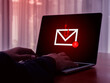 © tete_escape - E-mail spam phishing scammer concept. Red warning symbol on envelope in fishing hook icon as bait on laptop screen, criminal hacker cyberattack sending scam malware spreading virus sms text message.