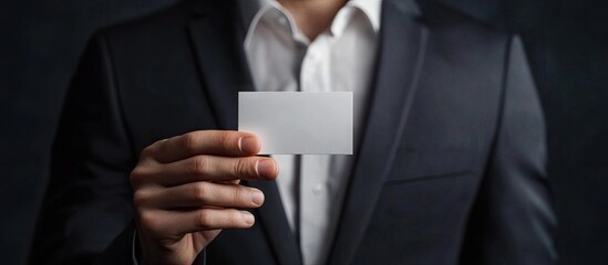 Poster - Portrait of a businessman displaying a business card. with copy space image. Place for adding text or design
