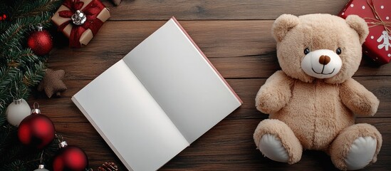 Poster - Christmas bear and white book viewed from the top with copyspace on a brown wooden table Concept of the Christmas festival