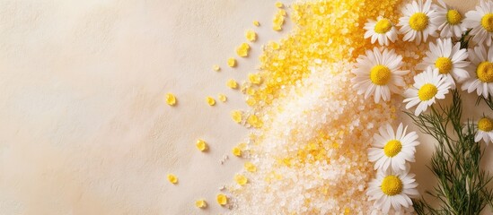 Poster - Bath salt from the sea with chamomile herbal extract a mound of yellow hued natural sea salt crystals and flowers Concept of aromatherapy and herbal medicine for body care cosmetics top view on a be