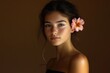 © Vii - A woman wearing a flower as an accessory in her hair, a beautiful and natural look