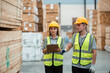 © eakgrungenerd - Team engineer carpenter wearing safety uniform and hard hat working holding clipboard checking quality of wooden products at workshop manufacturing. man and woman worker wood warehouse industry.