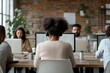 © Odin AI - A diverse group of people at a co-working space, focused on their work, showcasing teamwork, collaboration, and a modern office environment.