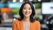 © Master of AI Arts - A joyful asian news anchor reading the news in a broadcast studio, smiling confidently, with a clean and modern set design