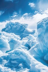 Large mountain range covered in snow and ice. The sky is clear and blue. Concept of vastness and isolation, as the mountains seem to stretch on forever