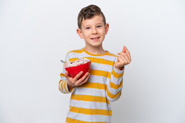 Little caucasian boy holding a cereal bowl isolated on white background making money gesture