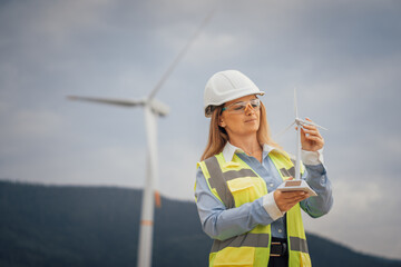 Poster - A female engineer is actively engaged in conducting maintenance on a wind turbine within the renewable energy sector, showcasing her expertise and commitment to sustainable engineering practices