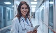 © useful pictures - A healthcare professional stands in a well-lit hospital corridor, smiling while holding a tablet. She is dressed in a white coat, ready to assist patients and support her team
