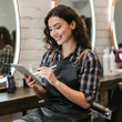 © ProArt Studios - Beauty work, woman with tablet in hair salon for job, planning and reading online appointment. Small business, client booking, portfolio and information