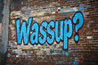 © Paolo - Colorful urban graffiti saying wassup on a brick wall.