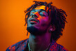 © Gonzalo - Close-up portrait of a young African-American man wearing sunglasses, singing passionately against a vibrant gradient background of blue and orange lights, capturing energy and artistic expression.