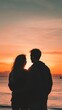 © fangphotolia - Silhouetted couple watching a sunset on the beach
