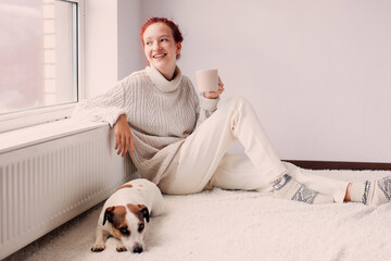 Young Woman Drinking hot coffee at white room